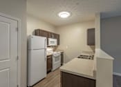 Thumbnail 4 of 31 - A kitchen with white appliances and a white refrigerator.