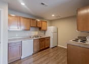 Thumbnail 51 of 78 - A kitchen with wooden cabinets and a white refrigerator.