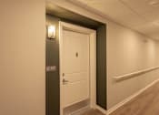 Thumbnail 11 of 37 - A white door with a handle and a number 217 on the wall.
