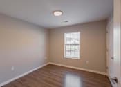 Thumbnail 35 of 56 - A room with a window and a wooden floor.