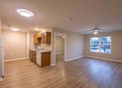 Thumbnail 18 of 37 - A kitchen with wooden floors and a refrigerator on the left.