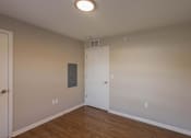 Thumbnail 58 of 76 - A room with a white door and a light on the ceiling.
