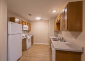 Thumbnail 20 of 37 - A kitchen with white appliances and wooden cabinets.