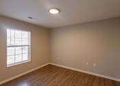 Thumbnail 57 of 78 - A room with a window and wooden flooring.