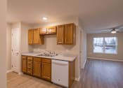 Thumbnail 13 of 37 - A kitchen with wooden cabinets and a white dishwasher.