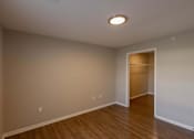 Thumbnail 61 of 78 - A room with a wooden floor and a white ceiling with a light fixture.
