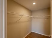 Thumbnail 54 of 78 - Empty room with white walls and wood flooring.