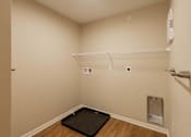 Thumbnail 60 of 76 - A room with a black mat on the floor and a white shelf above it.