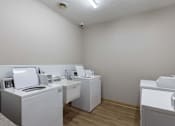 Thumbnail 10 of 29 - A room with white appliances and a white wall.