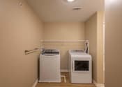 Thumbnail 20 of 37 - A laundry room with a washer and dryer.