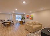 Thumbnail 29 of 37 - A living room with a couch, chairs, and a dining table.