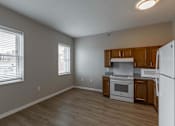 Thumbnail 9 of 29 - A kitchen with white appliances and wooden cabinets.