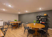 Thumbnail 25 of 37 - A dining room with a wooden table surrounded by chairs.