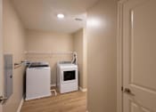 Thumbnail 9 of 37 - A laundry room with a washer and dryer.
