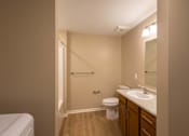 Thumbnail 10 of 37 - A bathroom with a toilet, sink, and shower.