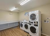 Thumbnail 59 of 84 - A laundry room with a washer and dryer.