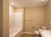 Thumbnail 6 of 37 - A bathroom with a toilet, sink, and bathtub.