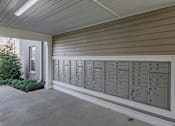 Thumbnail 23 of 56 - A long row of mailboxes are lined up on the side of a building.