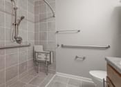 Thumbnail 11 of 29 - A bathroom with a toilet, sink, and shower.
