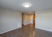 Thumbnail 28 of 56 - A room with a wooden floor and a ceiling light.