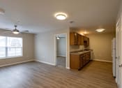 Thumbnail 1 of 24 - A kitchen with wooden cabinets and a ceiling fan.