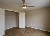 Thumbnail 13 of 24 - A room with a ceiling fan and a door.