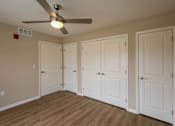 Thumbnail 15 of 24 - A room with a ceiling fan and four doors.