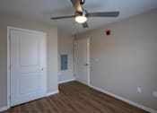 Thumbnail 17 of 24 - A room with a ceiling fan and two doors.