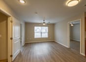 Thumbnail 2 of 24 - A room with a ceiling fan and a window.
