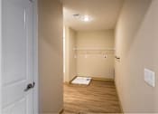 Thumbnail 7 of 24 - A hallway with a white door and a white wall.