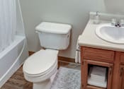 Thumbnail 26 of 26 - A white toilet sits next to a sink in a bathroom.