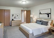 Thumbnail 24 of 26 - A bedroom with a large bed, a nightstand, and a dresser.