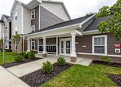 Thumbnail 17 of 30 - A two story building with a front porch and a sign that says FDC.