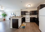Thumbnail 52 of 52 - A modern kitchen with black cabinets and a white refrigerator.