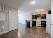 Thumbnail 35 of 52 - A kitchen with white appliances and black cabinets.