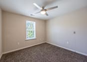 Thumbnail 36 of 52 - A room with a ceiling fan and a window.