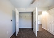 Thumbnail 46 of 52 - A large, empty room with a carpeted floor and white walls.