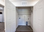 Thumbnail 47 of 52 - A white doorway leads to a small, empty room with a grey floor.