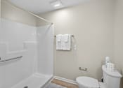 Thumbnail 28 of 31 - A white bathroom with a toilet, sink, and shower.