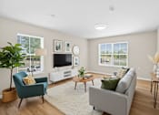 Thumbnail 31 of 31 - A living room with a grey couch, a blue armchair, a coffee table, and a television.