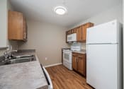 Thumbnail 28 of 58 - A kitchen with a white refrigerator, white oven, and white microwave.