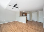 Thumbnail 31 of 58 - A room with a ceiling fan and wooden flooring.