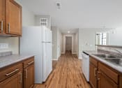 Thumbnail 50 of 58 - A kitchen with wooden cabinets and a white refrigerator.