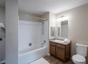 Thumbnail 58 of 58 - A white bathroom with a toilet, sink, and bathtub.