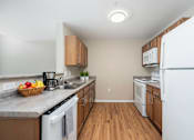 Thumbnail 56 of 58 - A kitchen with a white dishwasher and white refrigerator.