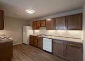 Thumbnail 15 of 58 - A kitchen with brown cabinets and a white refrigerator.