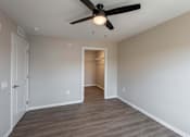 Thumbnail 20 of 58 - A room with a ceiling fan and light fixture.