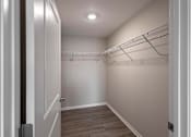 Thumbnail 22 of 58 - A walk-in closet with a light on the ceiling.
