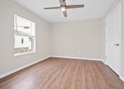 Thumbnail 42 of 64 - a bedroom with hardwood floors and a ceiling fan