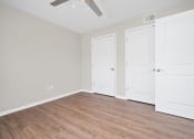 Thumbnail 38 of 64 - a bedroom with two doors and a ceiling fan